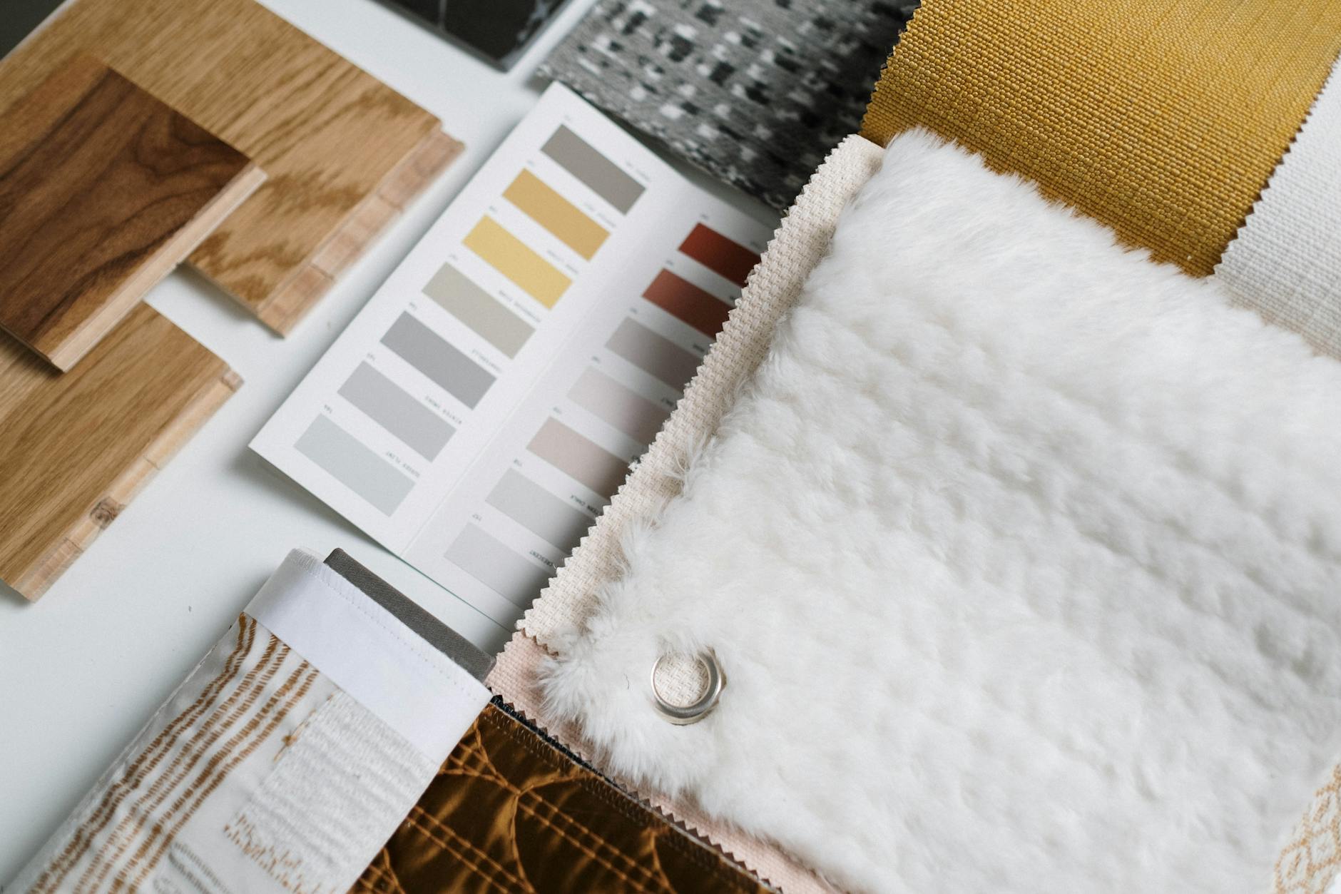 Wood, paint and fabric samples laid out together on a white table